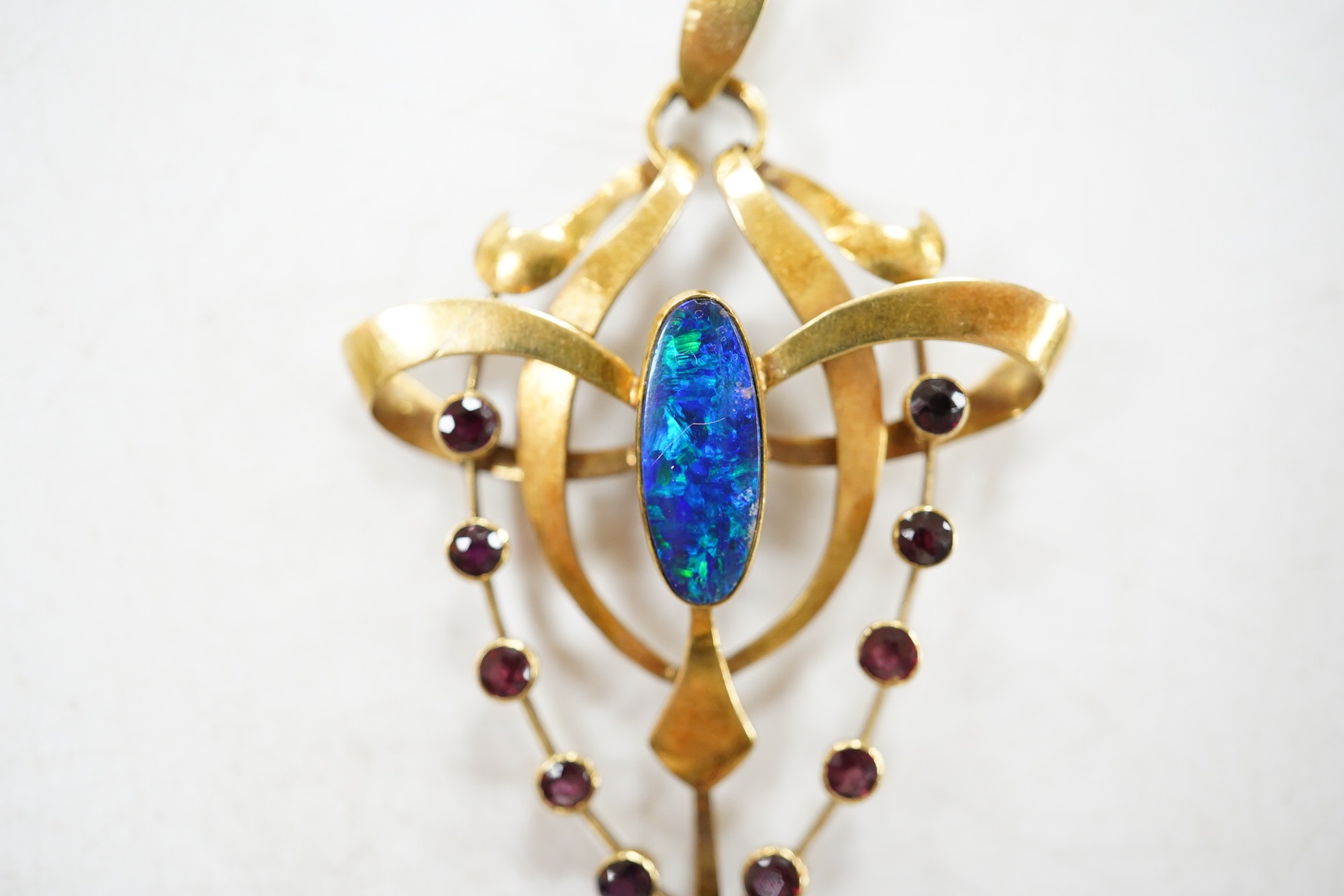 An Edwardian Art Nouveau 15ct, black opal doublet and ruby cluster set drop pendant, 55mm, gross weight 3.9 grams. Condition - fair to good